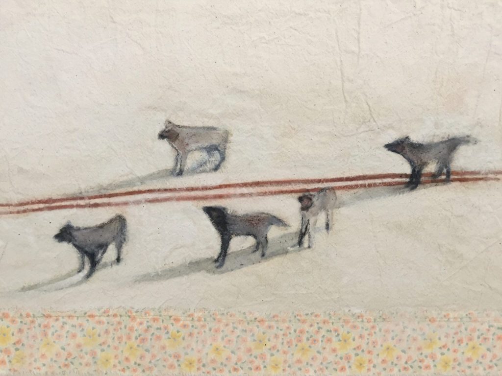 A painting on fabric of a pack of wolves with bloodied mouths following red ski tracks.