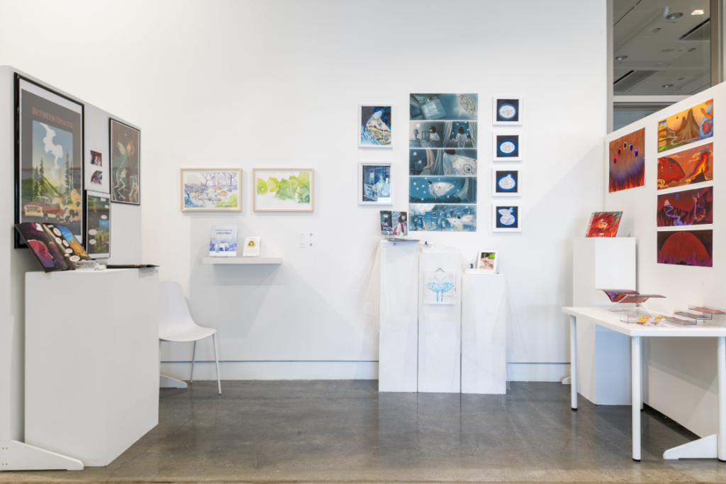 Installation view of various pieces in an enclosed three wall space, with various printed pieces mounted on the walls and podiums with smaller artifacts. 